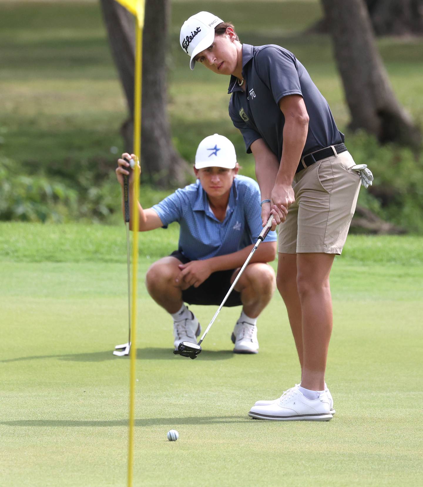 Sycamore’s Andrew Swedberg putts as St. Charles North’s Jack Van Laningham looks on Monday, Sept. 16, 2024, during the Mark Rolfing Cup at the Kishwaukee Country Club in DeKalb.