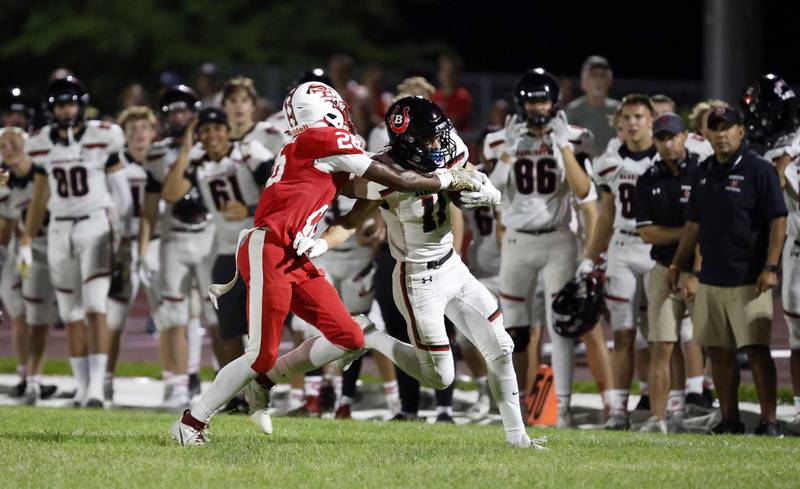 South Elgin's DeAngelo McCullough (26) wraps up Barrington's Matt Kania (11) Friday, Aug. 30, 2024 in South Elgin.