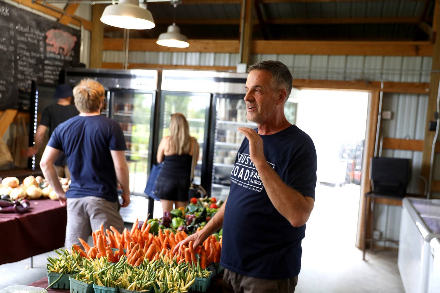 Owner and chef Mark Bernard talks with customers in the market at Rustic Road Farm in La Fox, which is located on the eastern edge of a proposed development. Atlanta developer Pulte Homes has submitted a concept plan application to the city for Charles Farm, a 970 acre housing development consisting of a 967 unit senior living community, 846 single-family homes, 198 townhomes and 15 acres of commercial development.