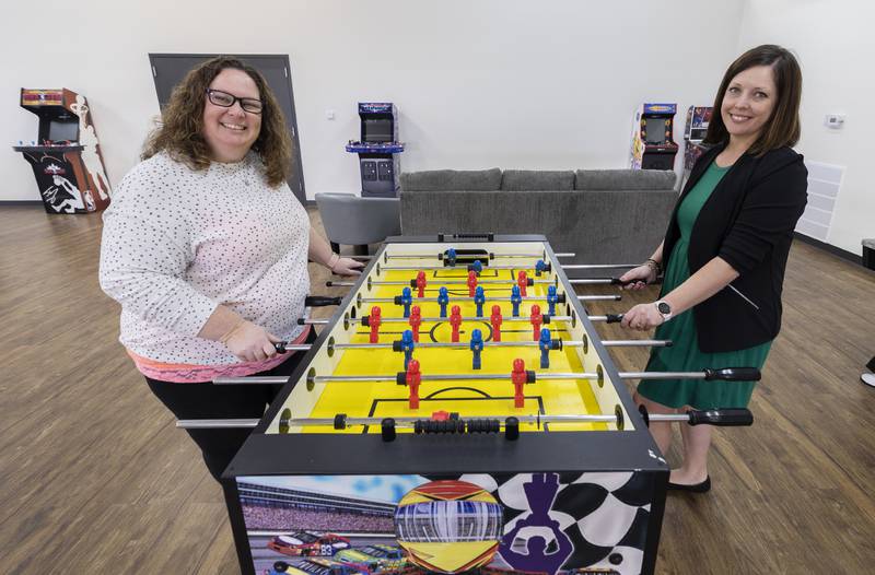 Youth director Heather Waninger (left) and Sterling Township supervisor Angie Schneider go head to head on a foosball table Tuesday, April 2, 2024, at the Elevate Youth Center.