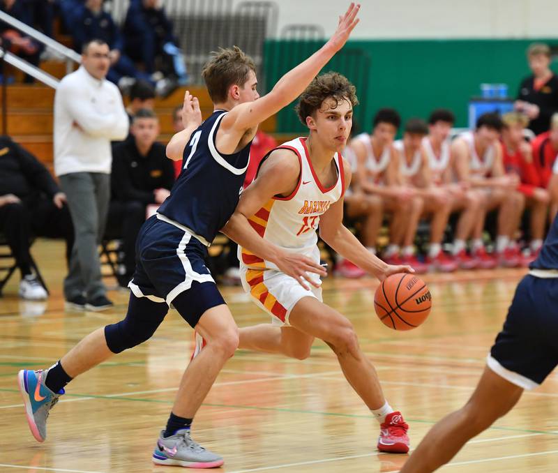 Batavia's Isaac Wit drives past Downers Grove South's Will Potter during a Jack Tosh Classic game on Dec. 26, 2023 at York High School in Elmhurst.