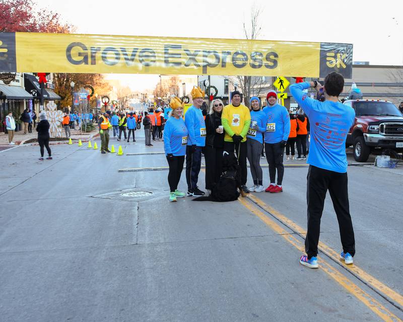 The Smith family of Downers Grove poses for a photo before the start of the Grove Express 5k race on Thursday Nov. 23, 2023.