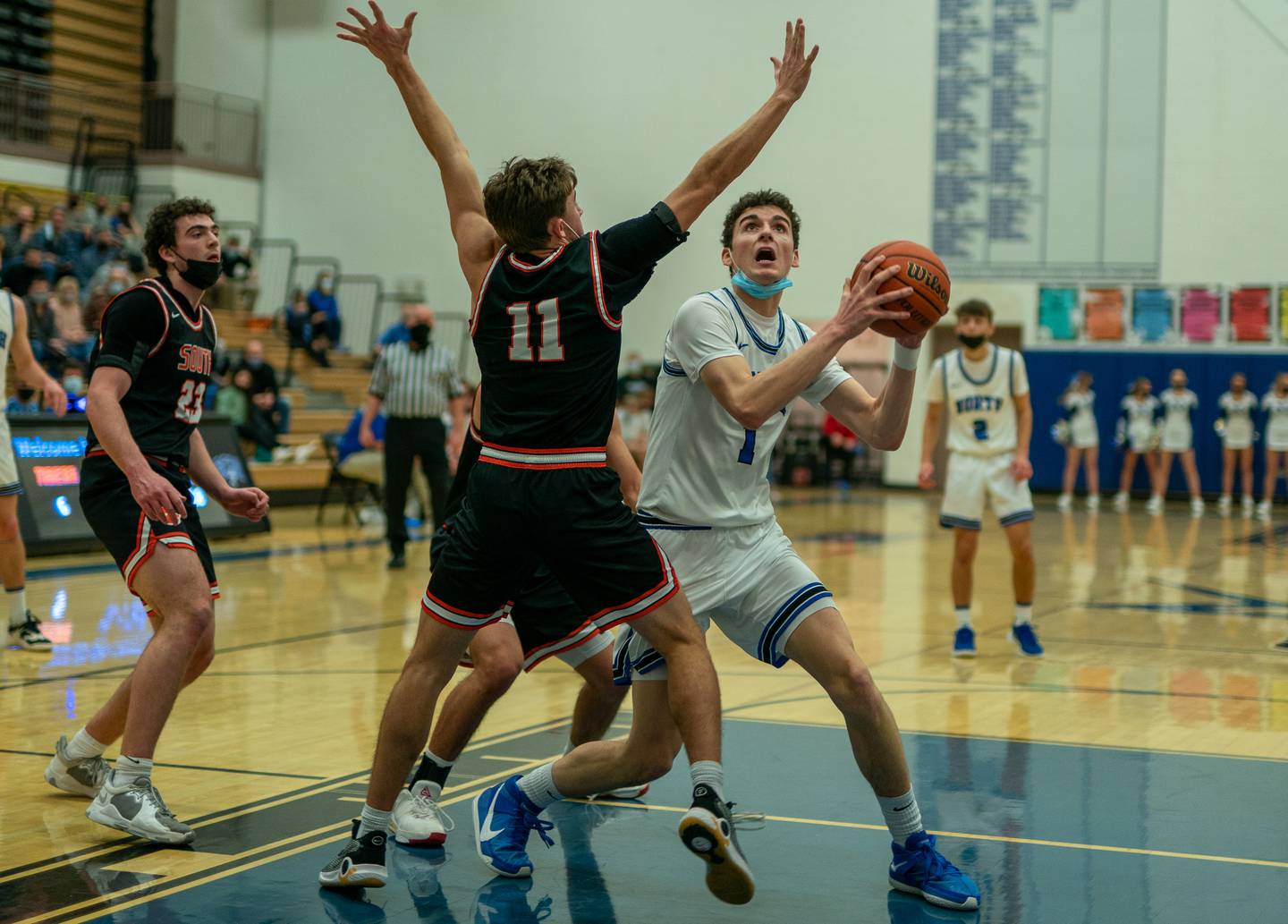 St. Charles North's Ethan Marlowe (1) plays the ball in the post against Wheaton Warrenville South's Danny Healy (11) during a basketball game at St.Charles North High School on Friday, Jan 21, 2022.