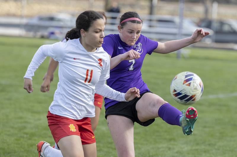 Dixon’s Madeline McLane plays the ball against Rock Island’s Kampbell Allen Friday, April 12, 2024 in Dixon.