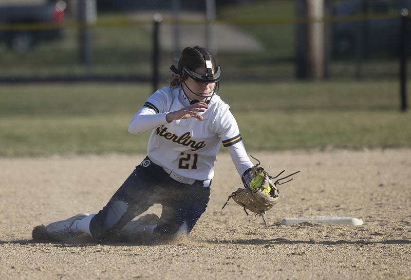 Sterling’s Katie Taylor scoops a trapped ball against Dixon Tuesday, March 19, 2024 in Dixon.