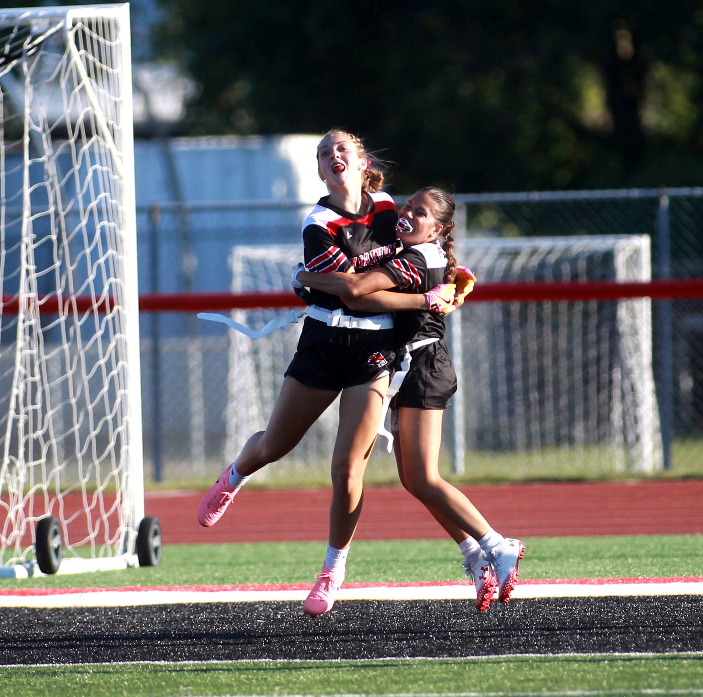 Yorkville’s Annabel West (left) celebrates her touchdown with teammate Dani Turner (right) during a flag football game Wednesday, Sept. 4, 2024 against West Aurora in Yorkville.