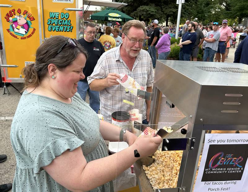 Melissa Rojas, executive director of the Mt. Morris Senior Center, was busy serving popcorn to the crowd during the opening night of the  Jamboree music series in downtown Mt. Morris on Friday, June 7, 2024. Brass from the Past was the featured band.