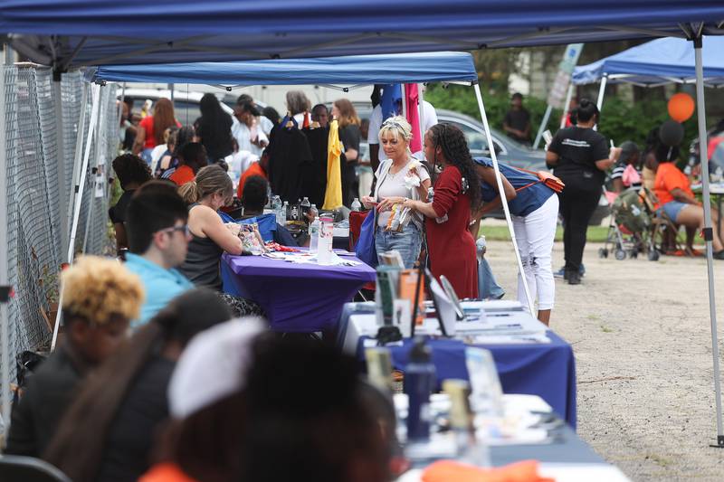 People browse the numerous business and organization tents set up at the Healing the Hood event held at the St. Mark CME Church in Joliet on Saturday June 29, 2024.