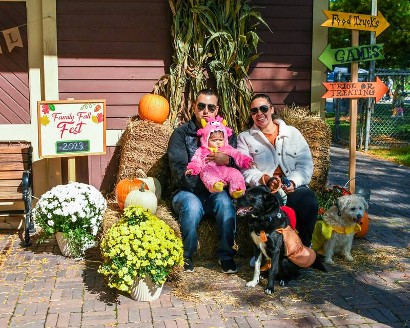 The Prado family of Carol Stream, Alyssa and Diego pose with their 7 month old, Adley, along with their two dogs Leo, 3 year old, left, and Taco 11 year old at the Family Fall Fest held at Wild Meadows Trace Park in downtown Elmhurst on Saturday Oct. 7, 2023.