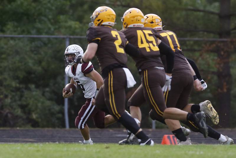 Prairie Ridge's Luke Vanderwiel runs away from the pursuit of Jacobs' Caden DuMelle, John Coates, and Vincent DeLord during a Fox Valley Conference football game on Friday, Aug 30, 2024, at Jacobs High School in Algonquin.