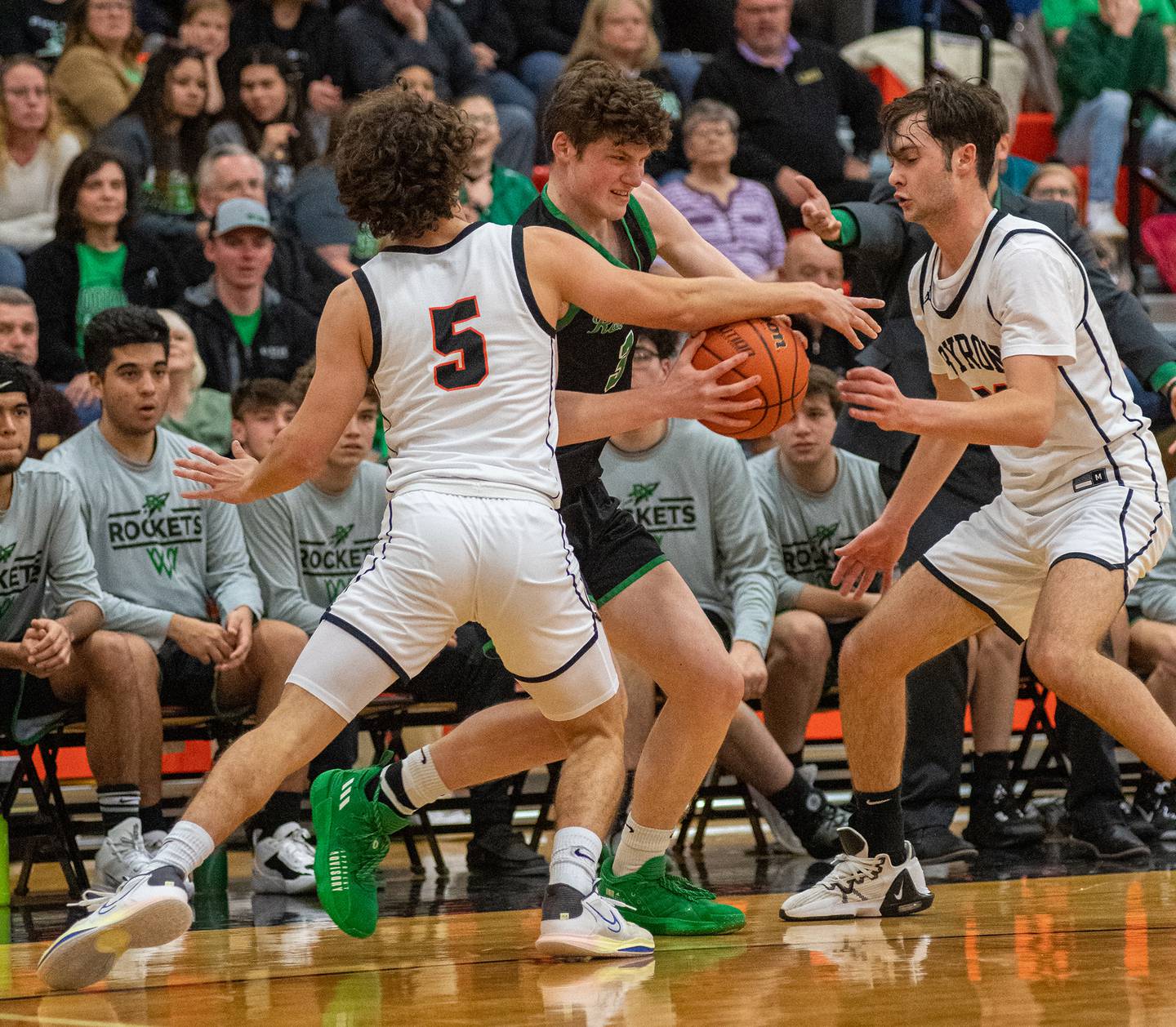 Rock Falls' Ryken Howard tries to split the double-team of Byron's Kye Aken (5) and Nick Kesler during the third quarter of the 2A Byron Regional championship game on Saturday, Feb. 25, 2023.