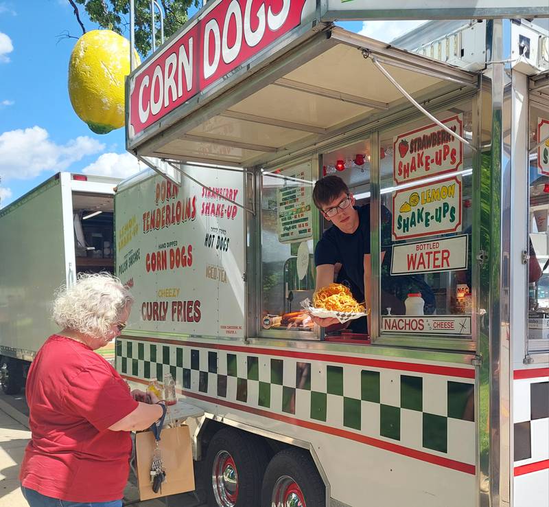 Cruisin Concessions serves an order of curly fries Saturday, May 18, 2024, during the Streator Food Truck Festival.