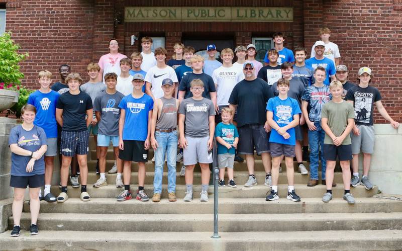 The Princeton Tiger football team showed their community spirit by moving boxes from the third floor of the Sash Stalter Matson Building to the basement in a matter of 15 minutes for the Bureau County Historical Society.
