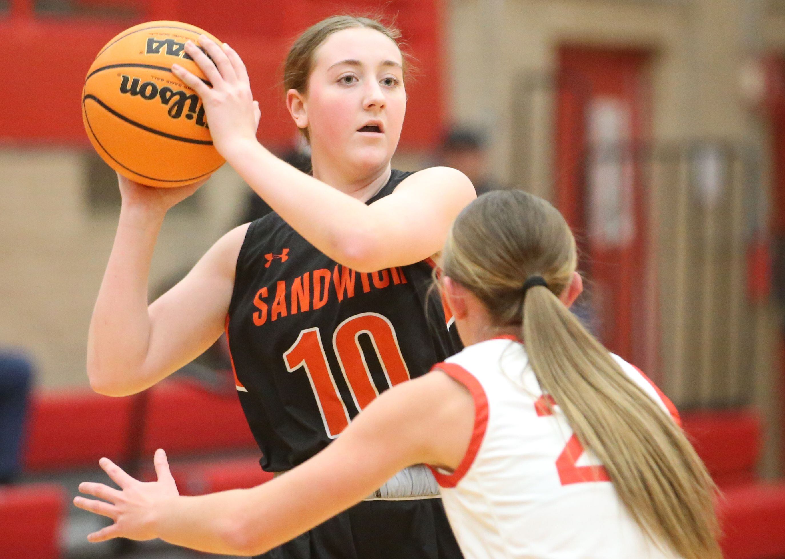 Sandwich's Kayden Cornelis looks to pass the ball around Ottawa's Ashlynn Ganiere on Monday, Jan. 27, 2025 in Kingman Gym at Ottawa High School.