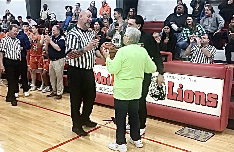 Ethel Blumhorst presented the game ball in support both of her grandsons Friday, DePue coach Trae Blumhorst and LaMoille coach Chance Blumhorst.