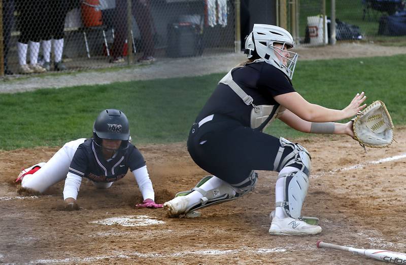 Huntley’s Sadie Svendsen slides into home plate in from of the throw to Prairie Ridge’s Reese Vrba during a Fox Valley Conference softball game on Monday, April 29, 2024, at Prairie Ridge High School.