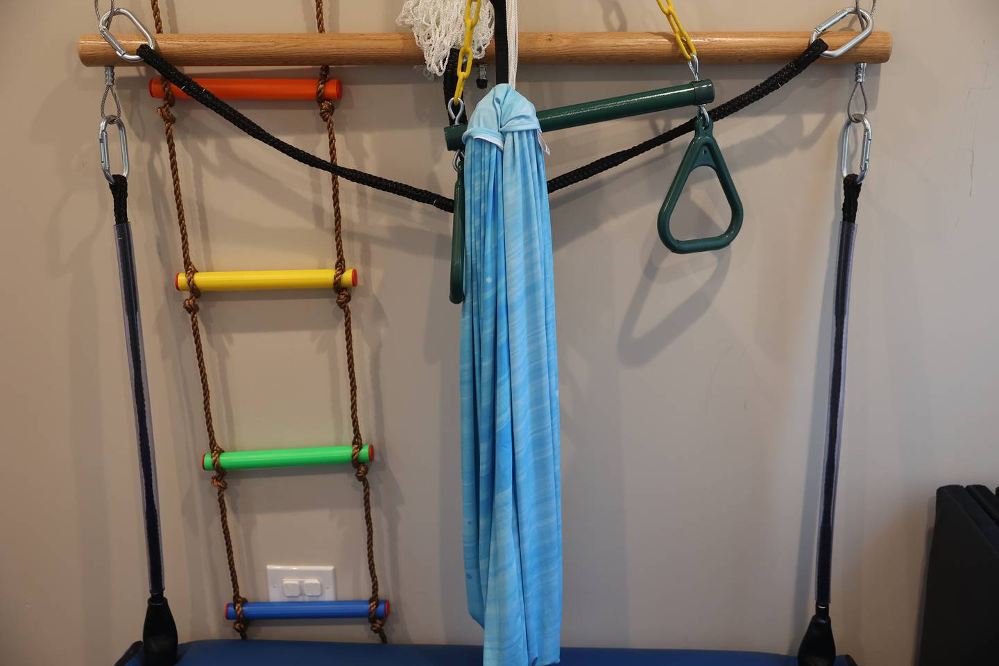 Various therapy equipment for young clients hangs on the wall at PFG Therapy on Tuesday, August 20, 2024 in Plainfield.