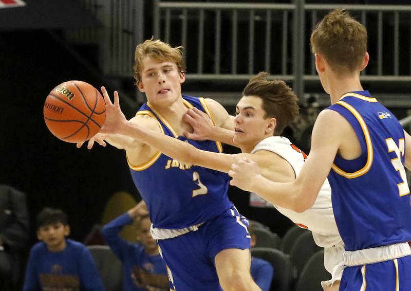 McHenry's Zachary Maness, center, steals a pass attended for Johnsburg's Dylan Schmidt, left, during a non-conference basketball game Sunday, Nov. 27, 2022, between Johnsburg and McHenry at Fiserv Forum in Milwaukee.