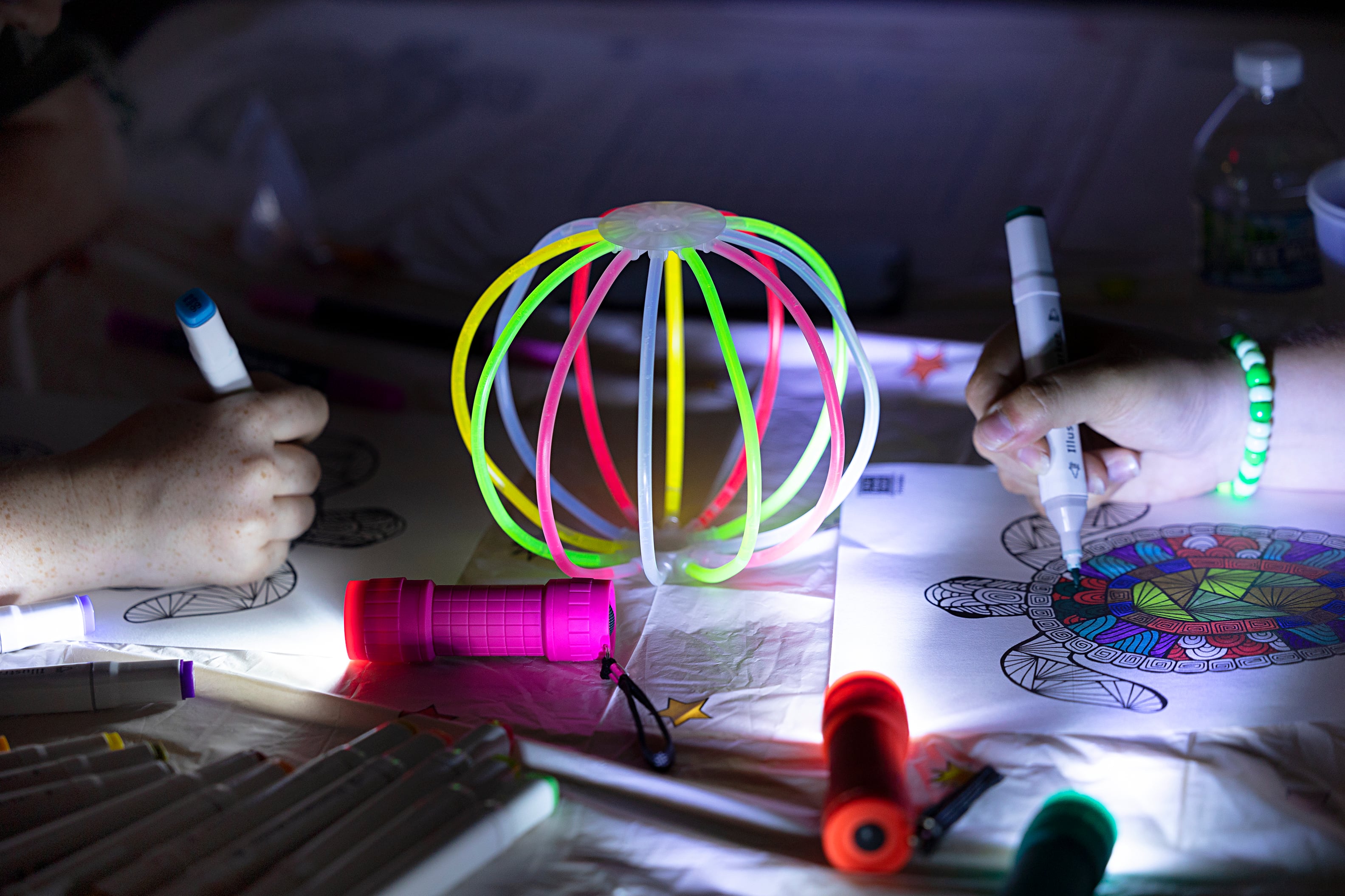 Lillyanna (left), 15, and Annalise Tranbarger 13, work on an art piece Tuesday, July 16, 2024, at the Dixon Public Library. Young adult librarian Brianna Doyle organized the glow party to bring in teens to the library. Doyle will host a program about once a quarter moving forward.