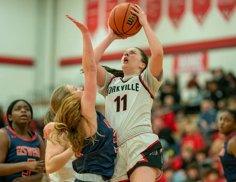 Yorkville's Brooke Spychalksi (11) shoots the ball in the post against Oswego’s Ashley Cook (33) during the 13th annual Hoops 4 Hope Communities vs. Cancer basketball event at Yorkville High School on Saturday, Jan 28, 2023.