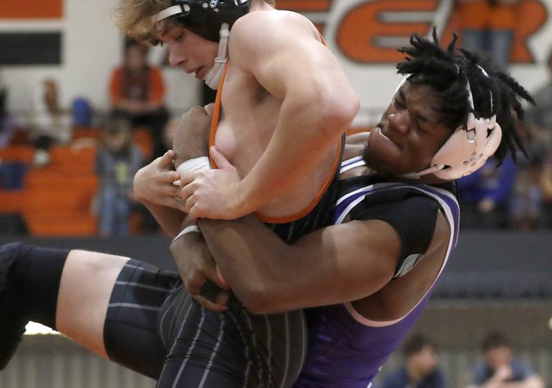 Crystal Lake Central’s Cayden Parks tries to get out of the grasp of Plano’s Prince Amakiri during the 190-pound championship match of a the IHSA 2A Crystal Lake Central Wrestling Regional on Saturday, Feb. 3, 2024, at Crystal Lake Central High School.