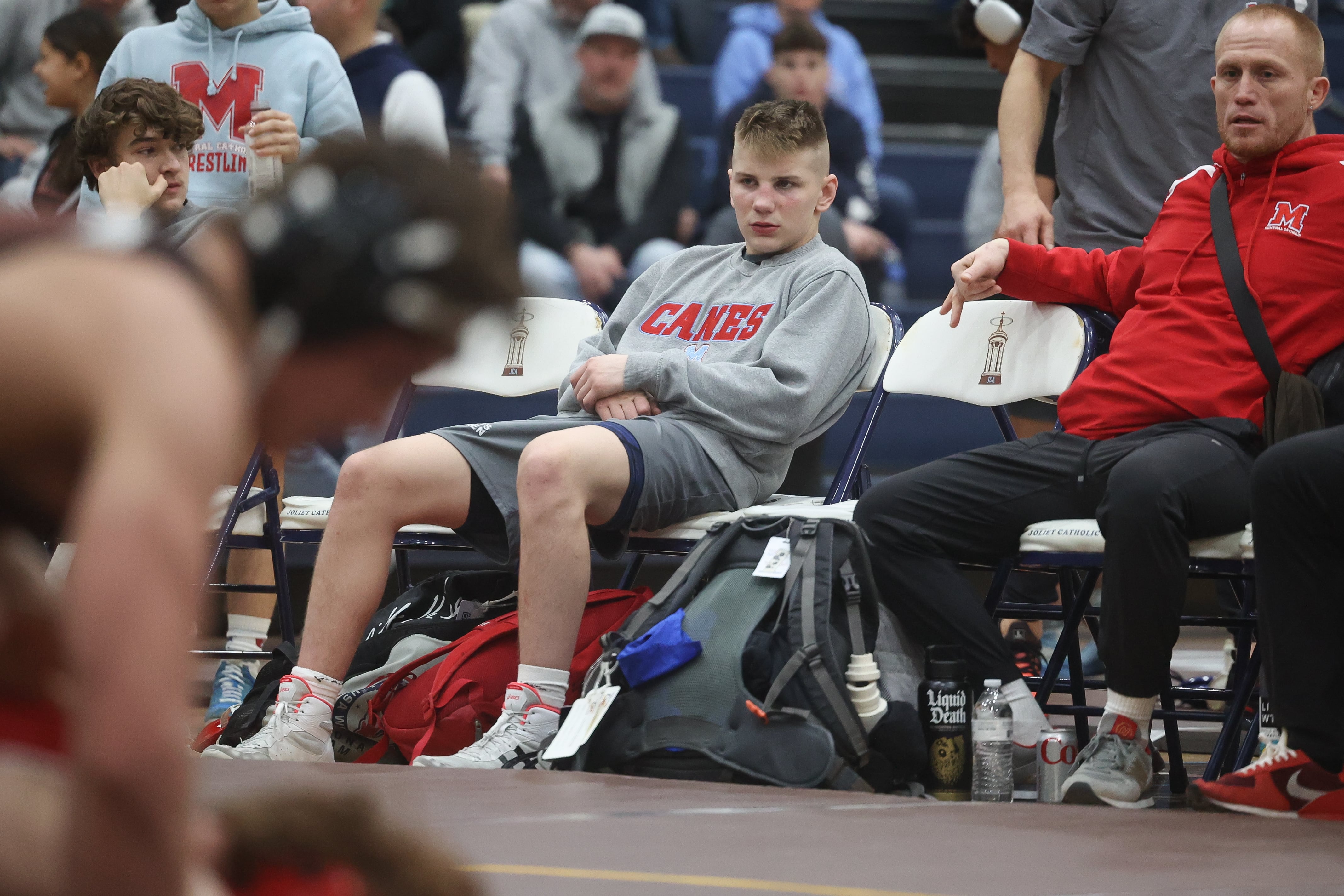 Marian Central’s Jimmy Mastny sits on the bench after his match against Joliet Catholic in the tri-meet at Joliet Catholic on Thursday, Jan. 18th, 2024 in Joliet.