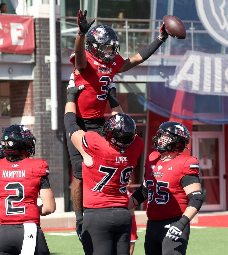 Northern Illinois' Trayvon Rudolph is hoisted by teammate J.J. Lippe after scoring a long touchdown during their game against Western Illinois Saturday, Aug. 31, 2024, in Huskie Stadium at NIU in DeKalb.