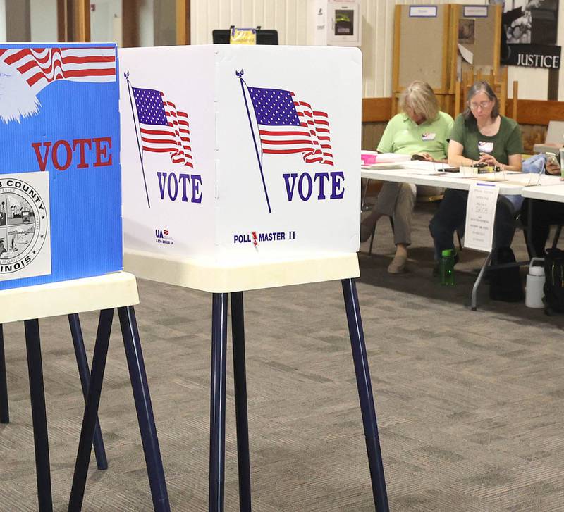 Election judges wait for the next voter to check in as voting booths remain idle during a slow period on election day Tuesday, June 28, 2022, at the polling place in Westminster Presbyterian Church in DeKalb.