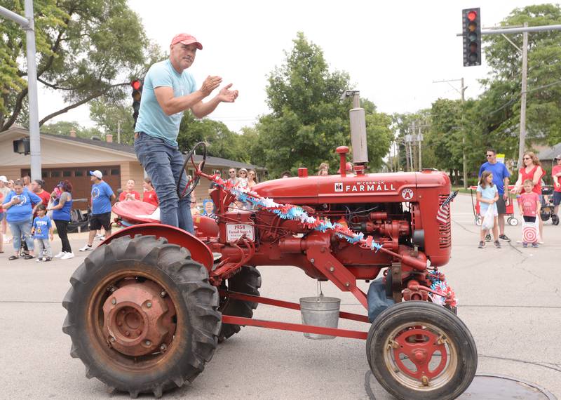 Downers Grove cross country and track coach Will Kupisch participates in the Downers Grove Fourth of July Parade on Thursday, July 4, 2024.