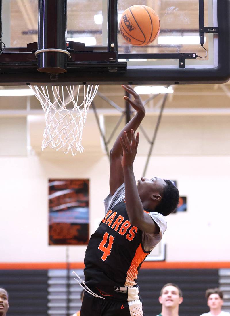 DeKalb’s Marquise Bolden gets a layup during their summer game against Elk Grove Tuesday, June 18, 2024, at DeKalb High School.