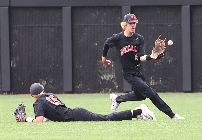 DeKalb's Cole Latimer fields a ball after it gets by a diving Paul Kakoliris during their Class 4A DeKalb Regional championship game against Huntley Friday, May 24, 2024, at Ralph McKinzie Field at Northern Illinois University in DeKalb.