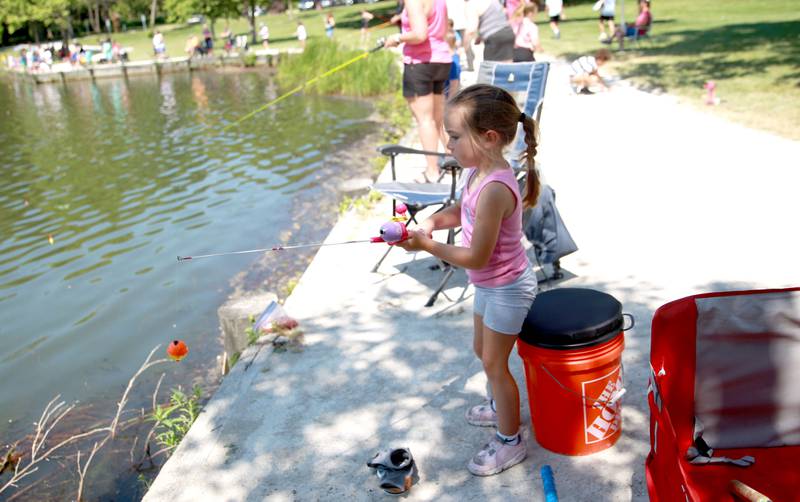 Brooklyn Gerst, 5, of Romeoville fishes at Herrick Lake Forest Preserve during the DuPage Forest Preserve Police Cops and Bobbers event in Wheaton on Wednesday, June 19, 2024.