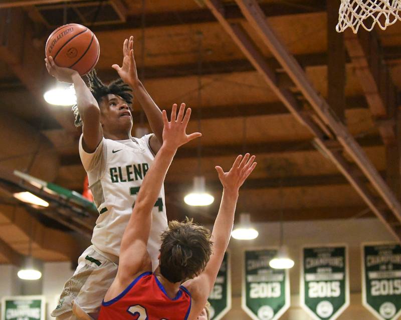 Glenbard West's TJ Williams, left, makes a shot in the second quarter while being defended by Glenbard South's Harper Bryan during the 2023 District 87 Invite held at Glenbard West.