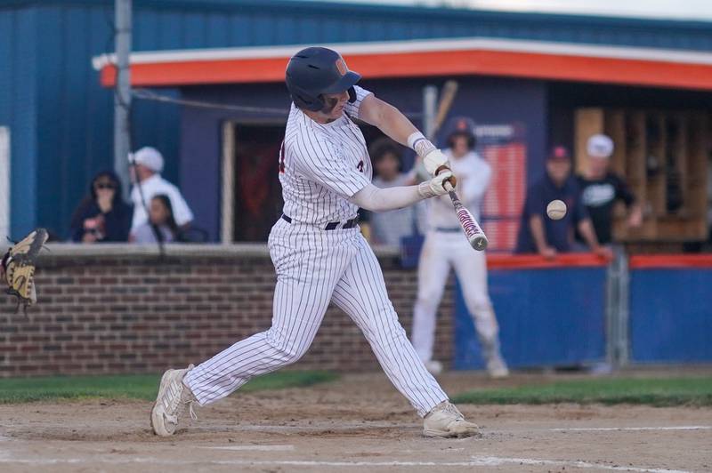 Oswego’s Dylan King (20) hits a three run homer against Yorkville during a baseball game at Oswego High School on Monday, April 29, 2024.