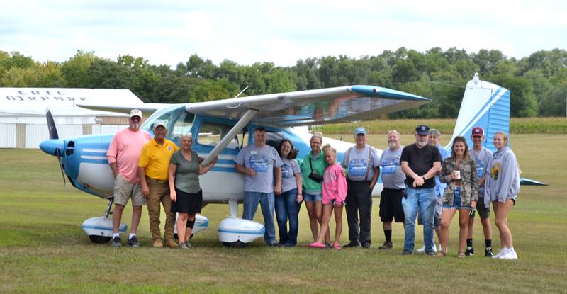 The last of the Challenger Fly-in guests gather for a photo in front of a Cessna 172L bound for Mississippi on Sunday, Aug. 27.