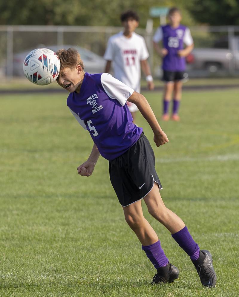 Dixon’s Nolan Valk heads a ball against Oregon Wednesday, Sept. 11, 2024, at EC Bowers field in Dixon.