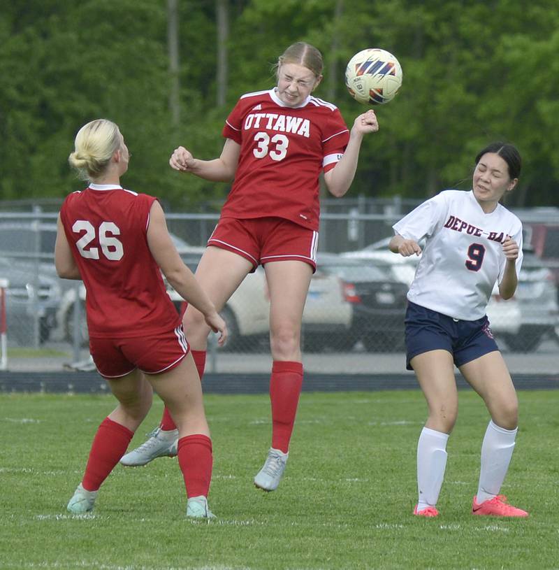 Ottawa’s Sariah Polier (33) gets in a header as teammate Taylor Brandt (26) and DePue/Hall's Yoanna Gutierrez (9) look on Thursday, May 2, 2024, at King Field in Ottawa.