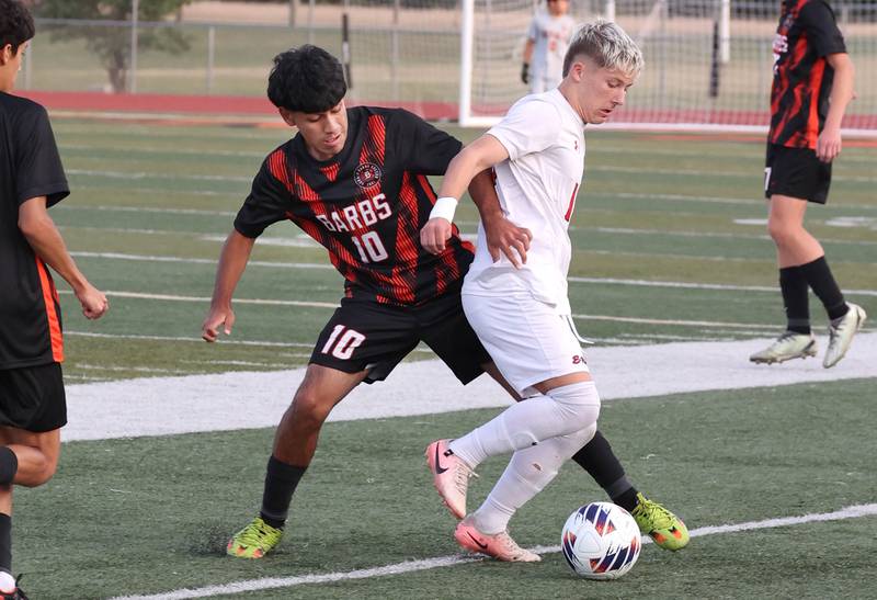 DeKalb's Matais Gutierrez and Rockford East's Aidan Aarli fight for possession during their game Thursday, Sept. 12, 2024, at DeKalb High School.