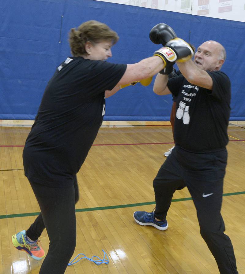 Elaine McKinney spars with Ken Beutke during her Rocksteady Boxing class at the Streator YMCA.