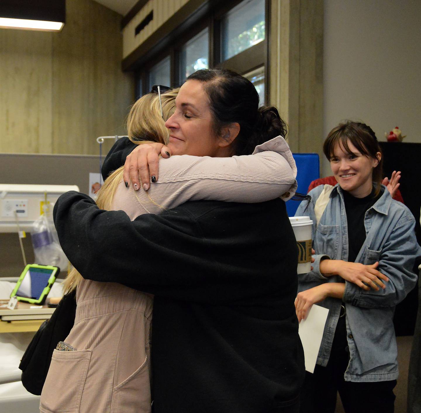 Amber Robertson (right) hugs nursing graduate Alex Hunt after learning Hunt nominated her for an outstanding teacher award through Shaw Local Radio. Robertson is now eligible for the organization’s Teacher of the Year award.