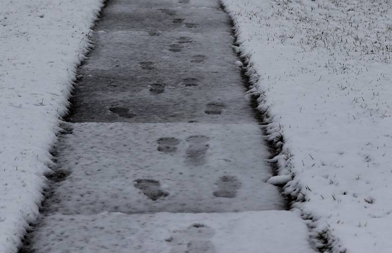 Footballs are covered by some more snow near the intersection of Walkup Avenue and Brink Street in Crystal Lake as a winter storm moves through McHenry County on Tuesday, Jan. 9, 2024, delivering snow to most of the county.