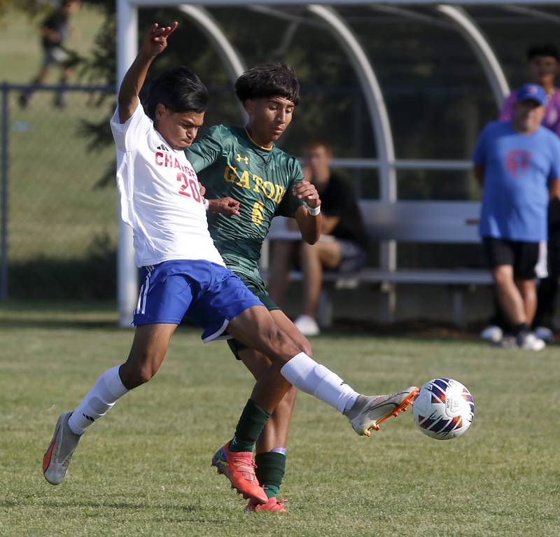 Dundee-Crown's Jonathan Troncoso kicks the ball away from Crystal Lake South's Hayden Stone during a Fox Valley Conference soccer match on Tuesday, Sept. 10, 2024, at Crystal Lake South High School.