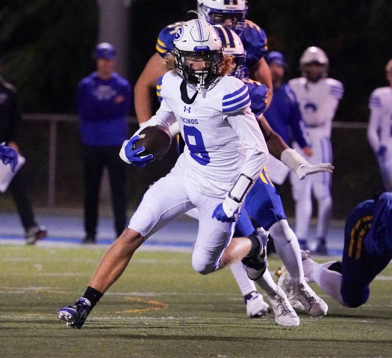 Geneva’s Finnegan Weppner (8) carries the ball against Wheaton North during a football game at Wheaton North High School on Friday, Oct. 6, 2023.