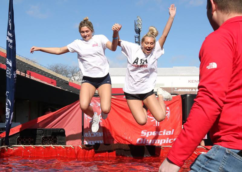 Members of the Alpha Sigma Alpha sorority jump into the water on a cold and windy Saturday, Feb 17, 2024, during the Huskie Stadium Polar Plunge at Northern Illinois University in DeKalb. The Polar Plunge is the signature fundraiser for Special Olympics Illinois.