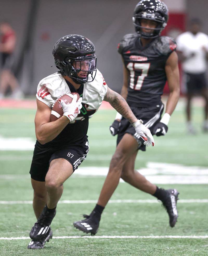 Northern Illinois University receiver Cam Thompson picks up yardage after a catch Tuesday, March 26, 2024, during spring practice in the Chessick Practice Center at NIU.