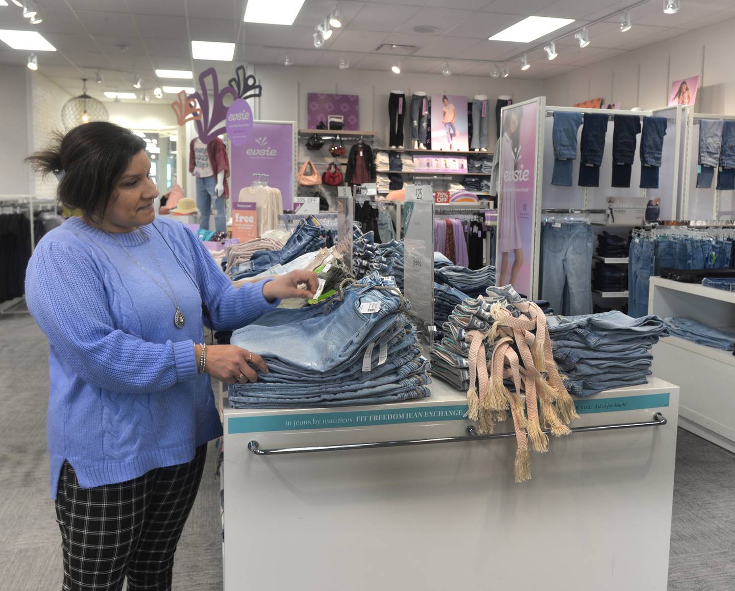 Olivia Smith, the manager of Maurices, stands by some of the clothing items for sale on Thursday, Feb. 8, 2024. The new store opened Feb. 2, 2024 at Sterling Crossing, across from their former location in the Northland Mall.