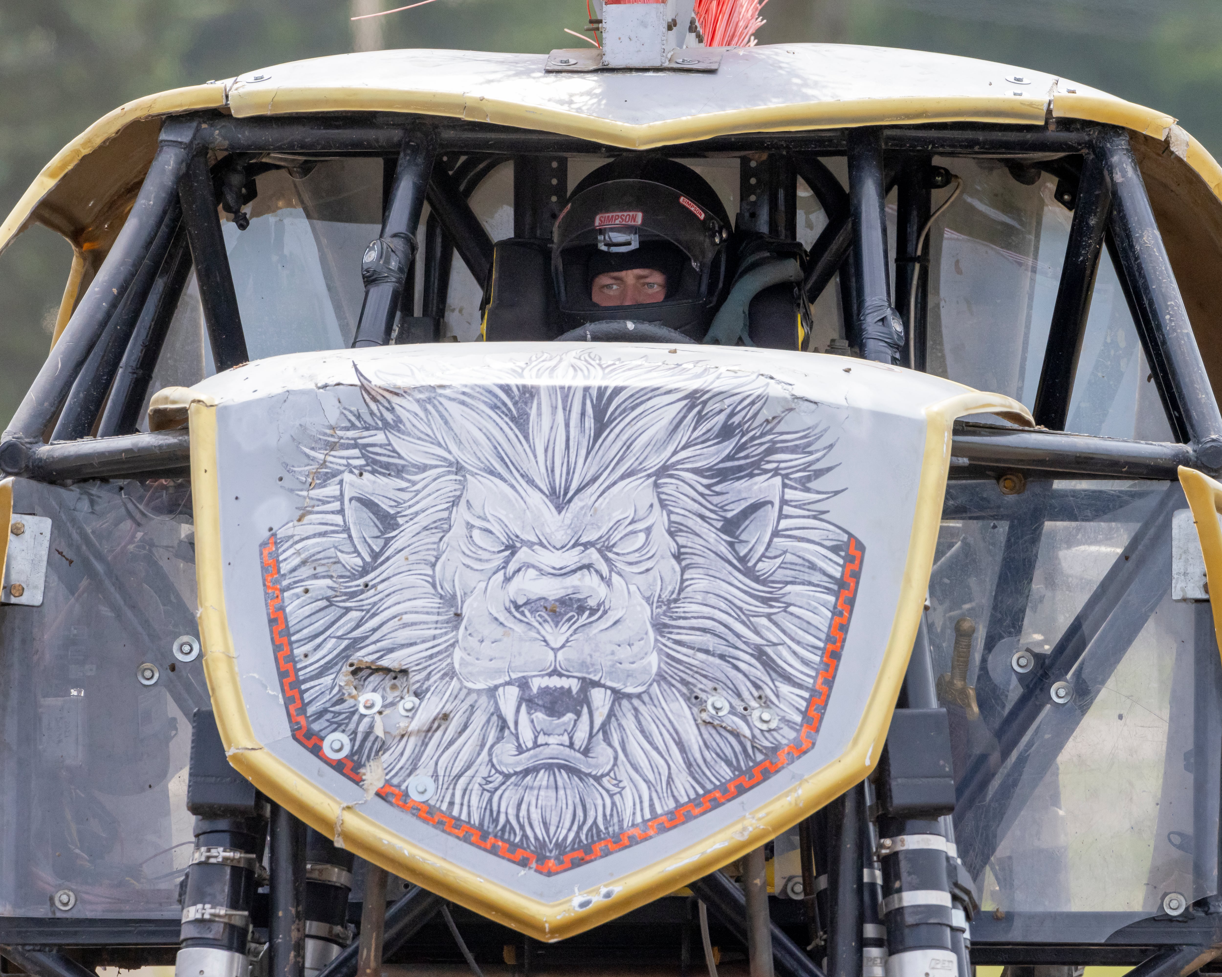 Maximus driver Travis Groth watches a fellow competitor's truck compete while he waits for his turn Saturday, July 20, 2024, during the Overdrive Monster Truck Show at Bureau County Fairgrounds.