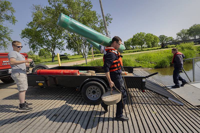 Sterling firefighter Jonah Bass hauls a buoy and its weight to the boat Wednesday, May 15, 2024.