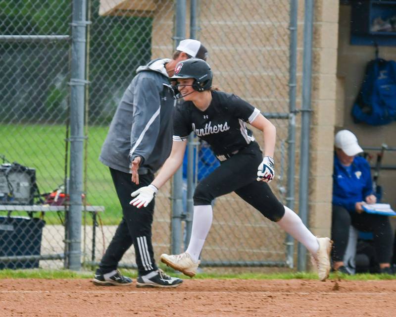 Glenbard North's Tru Medina (34) gets congratulated by her coach after hitting a home run during the game on Monday May 13, 2024, while traveling to take on Wheaton North High School.