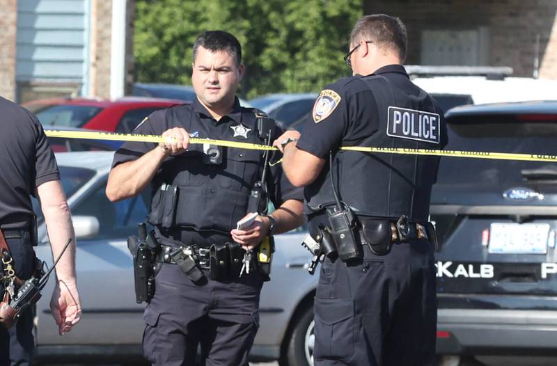 DeKalb Police officers hang tape at the scene of a shooting Wednesday, Aug. 24, 2022, at West Ridge Apartments in DeKalb.